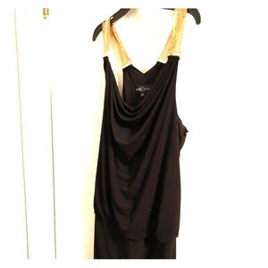 Black cocktail dress with gold chain straps.